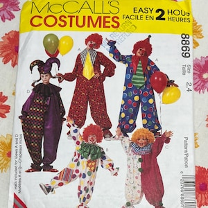 May include: A McCall's costume pattern featuring various clown costumes. The cover displays images of children in colorful clown outfits with wigs, makeup, and balloons. The pattern includes sizes 2, 4 and the text "EASY 2 HOURS".