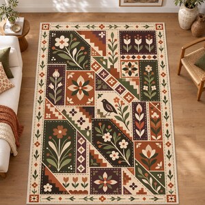 May include: A rectangular area rug featuring a geometric patchwork design with a cream background. The pattern includes dark green, terracotta, and brown panels decorated with various floral motifs, stair-step shapes, and a central black bird.