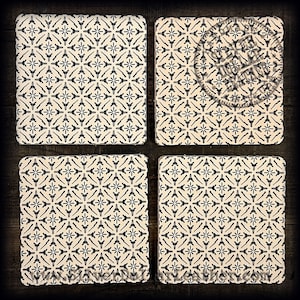 May include: Set of four square coasters with a black and white geometric pattern. The coasters are made of a light beige material and have a slightly textured surface.