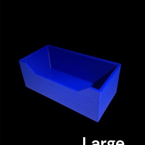 May include: A blue rectangular container with textured sides and a slanted opening. The word "Large" is printed in white at the bottom of the image. The container is set against a black background.