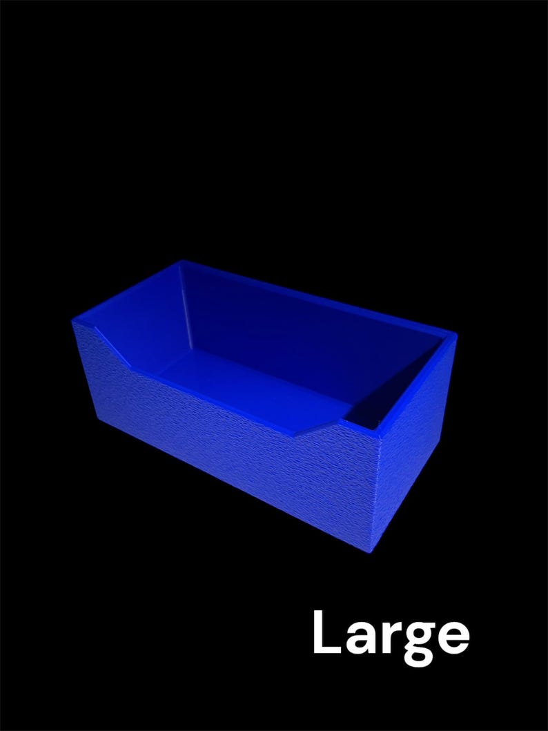 May include: A blue rectangular container with textured sides and a slanted opening. The word "Large" is printed in white at the bottom of the image. The container is set against a black background.
