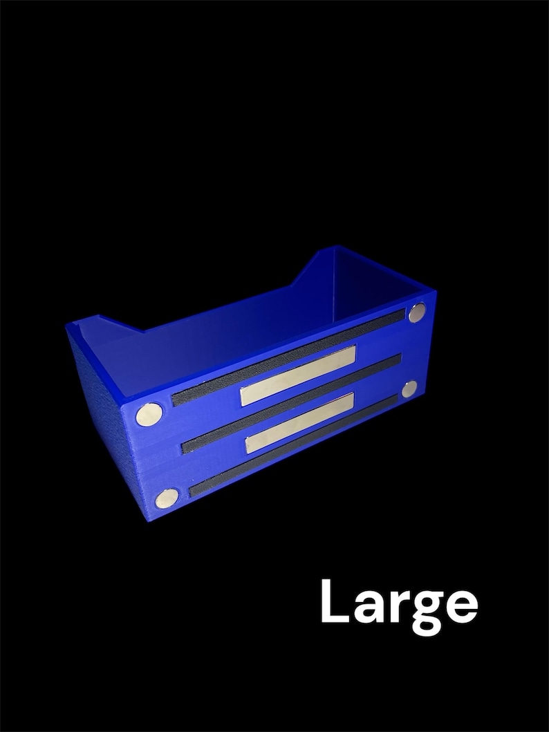 May include: A blue rectangular storage container with a textured surface. The container has two black strips with silver accents and four silver circular magnets. The word "Large" is printed in white.