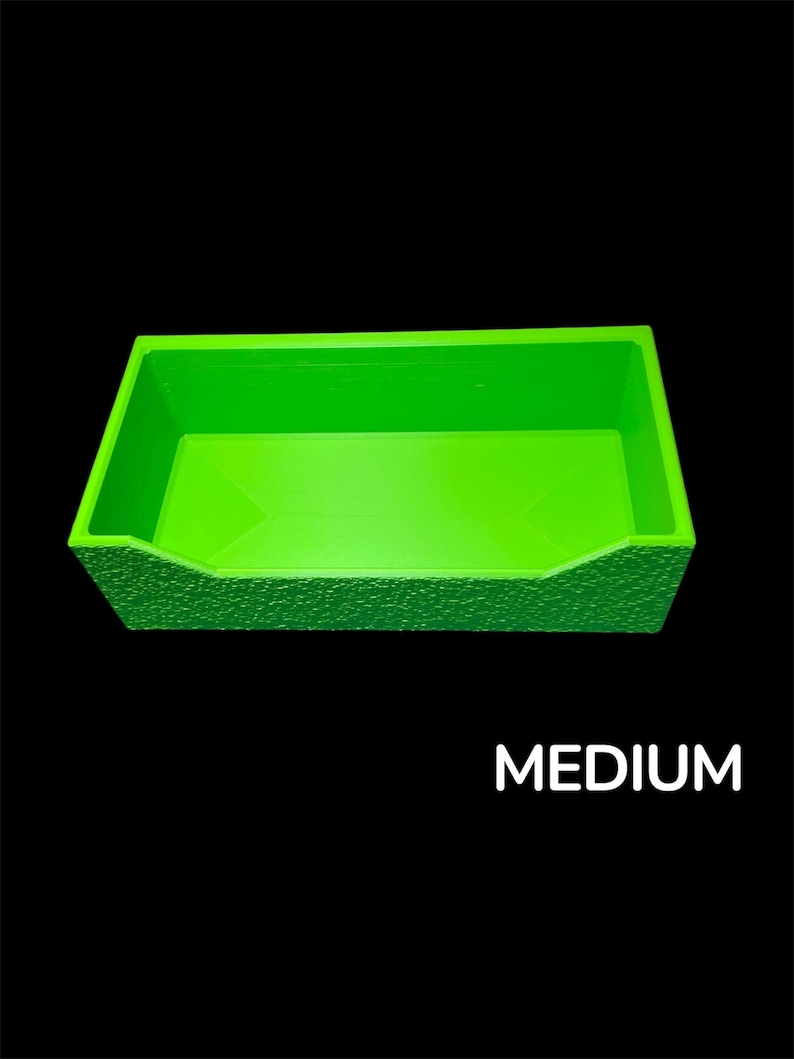 May include: A bright green rectangular container with a textured exterior and the word "MEDIUM" in white text. The container is set against a black background.