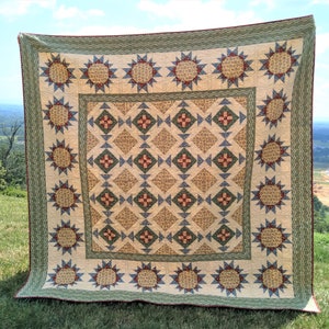 May include: A large quilt with a patchwork design featuring a central pattern of red and blue squares surrounded by a border of green and white stars. The quilt is made of cotton fabric and has a rustic, vintage aesthetic.
