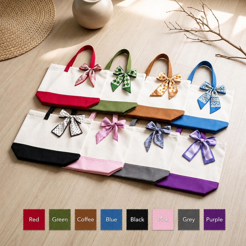 A collection of colorful tote bags with bows, arranged on a wooden surface.