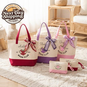 Three tote bags with personalized text and bows, along with two small bags, are displayed on a rug in a room with a woven chair and a basket.