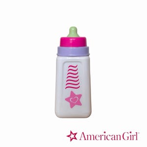 May include: A white plastic toy bottle with a light green nipple, a bright pink collar, and a lavender ring. The bottle features a vertical stack of pink wavy lines above a pink star containing a small heart. The text American Girl is below.