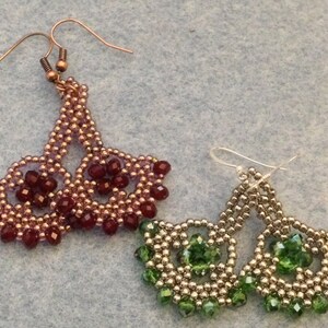 May include: A pair of earrings with a silver tone finish and green crystal beads. A second pair of earrings with a copper tone finish and burgundy crystal beads.