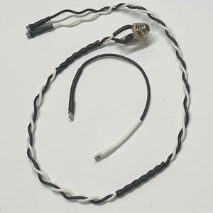 May include: An assortment of black and white braided electrical wires with connectors. The image shows a 1/4 inch audio jack, a USB-C connector, and a small connector with two pins. The wires are likely for audio or electronic devices.