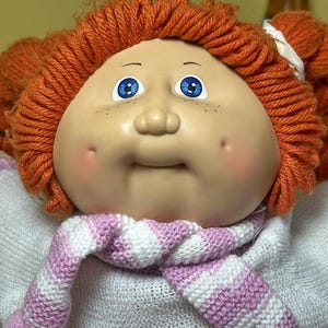 May include: A set of three ceramic mugs with a speckled, matte finish. The mugs are in shades of cream, light gray, and dark gray. Each mug has a simple, minimalist design and a rounded handle. Perfect for coffee or tea.