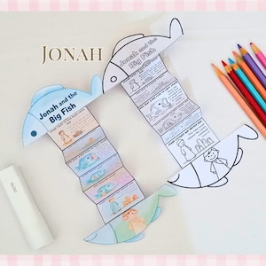 May include: Two fish-shaped paper crafts with the text "Jonah and the Big Fish" and illustrations. One is coloured, the other is black and white. The word "Jonah" is above the crafts. Coloured pencils and a white bottle are also in the image.