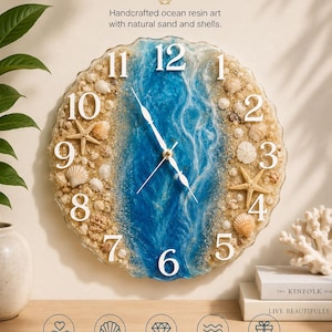 May include: A round wall clock featuring a blue resin center with white wave patterns, surrounded by natural sand and various seashells. The clock face has large white numbers from 1 to 12 and white hands. Text reads OCEAN and Handcrafted ocean resin art.