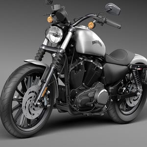 May include: A silver and black motorcycle with the Harley-Davidson logo on the fuel tank. The motorcycle has a round headlight, black tires, and a black seat. The motorcycle is on a gray background.
