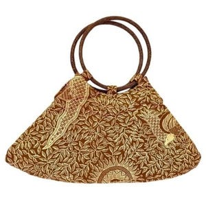 May include: Brown and gold patterned handbag with a circular handle. The bag features a floral design with a sunburst pattern at the bottom. The handles are a darker brown, and the bag has a triangular shape.