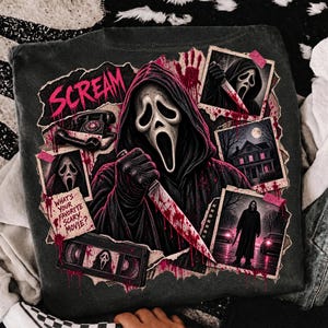 May include: A charcoal gray t-shirt featuring a graphic print of the Ghostface character from Scream. The design includes the text "SCREAM" and "WHAT'S YOUR FAVORITE SCARY MOVIE?", a rotary phone, a VHS tape, and three framed scenes of the masked figure.