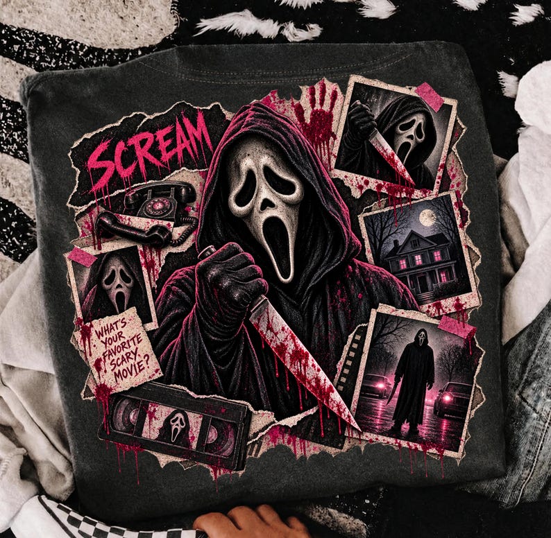 May include: A charcoal gray t-shirt featuring a graphic print of the Ghostface character from Scream. The design includes the text "SCREAM" and "WHAT'S YOUR FAVORITE SCARY MOVIE?", a rotary phone, a VHS tape, and three framed scenes of the masked figure.