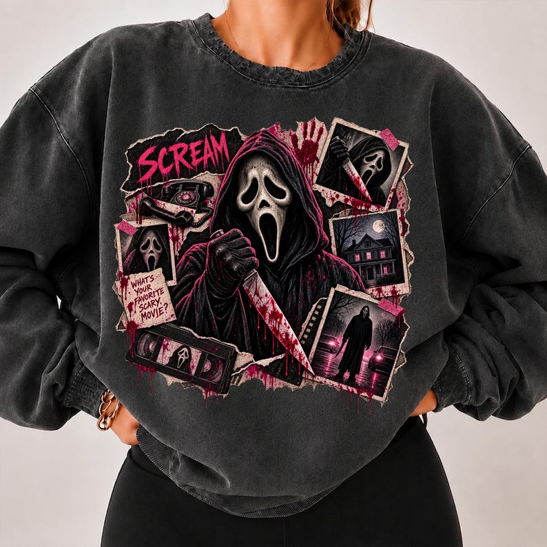 May include: A charcoal gray crewneck sweatshirt featuring a graphic print of the Ghostface character from the Scream movie franchise. The design includes a central figure holding a knife, a VHS tape, a rotary phone, and text reading Scream and What's Your Favorite Scary Movie?