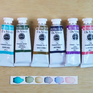I handpicked these colors for their AMAZING performance!!! The Da Vinci Tropical Palette includes 6 half pans of the following colors: Sage & Amber, Joyce's Mother Violet, Denise's New Green, Artemis, Seaglass, Da Vinci Red Tint. Each is a professional-grade fine arts watercolor paint. I have these in stock, ready to ship in Half Pans, Quarter Pans, or dot cards.