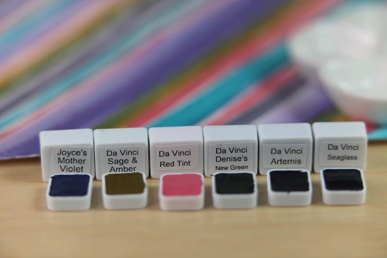 I handpicked these colors for their AMAZING performance!!! The Da Vinci Tropical Palette includes 6 half pans of the following colors: Sage & Amber, Joyce's Mother Violet, Denise's New Green, Artemis, Seaglass, Da Vinci Red Tint. Each is a professional-grade fine arts watercolor paint. I have these in stock, ready to ship in Half Pans, Quarter Pans, or dot cards.