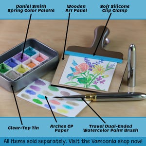 Entire watercolor travel setup including: Daniel Smith Spring Color Palette, Wood Art Panel, Soft Silicone Clip Clamp, Clear-Top Tin, Arches Cold-Pressed Watercolor Paper and a Travel Dual-Ended Watercolor Paint Brush. All sold separately in the Vamoonia shop.
