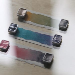 I handpicked these colors for their AMAZING performance!!! The Da Vinci Tropical Palette includes 6 half pans of the following colors: Sage & Amber, Joyce's Mother Violet, Denise's New Green, Artemis, Seaglass, Da Vinci Red Tint. Each is a professional-grade fine arts watercolor paint. I have these in stock, ready to ship in Half Pans, Quarter Pans, or dot cards.