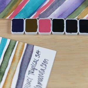 I handpicked these colors for their AMAZING performance!!! The Da Vinci Tropical Palette includes 6 half pans of the following colors: Sage & Amber, Joyce's Mother Violet, Denise's New Green, Artemis, Seaglass, Da Vinci Red Tint. Each is a professional-grade fine arts watercolor paint. I have these in stock, ready to ship in Half Pans, Quarter Pans, or dot cards.