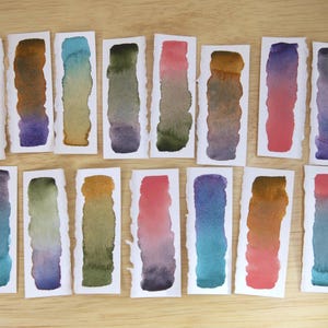 Swatches of the Da Vinci Tropical Palette which includes 6 half pans of the following colors: Sage & Amber, Joyce's Mother Violet, Denise's New Green, Artemis, Seaglass, Da Vinci Red Tint