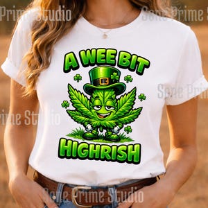 Könnte beinhalten: Weißes T-Shirt mit einer Cartoon-Cannabisblatt-Figur, die einen grünen Koboldhut trägt. Der Text "A Wee Bit Highrish" ist grün. Das Design beinhaltet Kleeblätter und ein lächelndes Gesicht.