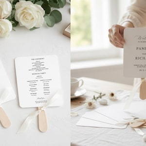 May include: White square wedding program fans with rounded corners, featuring black serif and script text that reads Welcome to the wedding of Pamela and Richard, including date and location, attached to wooden sticks with white satin ribbons.