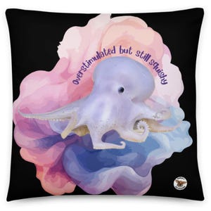 May include: A decorative throw pillow with a black background featuring a light purple octopus illustration. The octopus is set against a watercolor-style background of pink, blue, and purple hues. The text "overstimulated but still squishy" is written on the pillow.