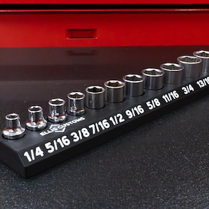 May include: A set of chrome sockets in various sizes, arranged on a black holder. The holder has white text indicating the socket sizes, ranging from 1/4 to 7/8 inches. The brand "Ellis Customs" is also visible.
