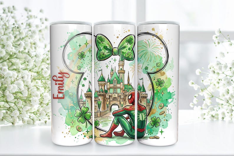 May include: A white tumbler featuring a watercolor design with a green bow, castle, and Spider-Man. The design includes shamrocks, fireworks, and the name "Emily" in red script. The tumbler has a cylindrical shape.