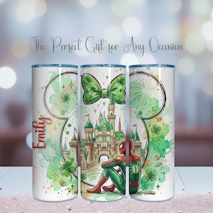 May include: A white tumbler featuring a green bow, a castle, and a seated Spider-Man. The design includes a Mickey Mouse head outline, clovers, and the name "Emily" in red. The text "The Perfect Gift for Any Occasion" is also present.