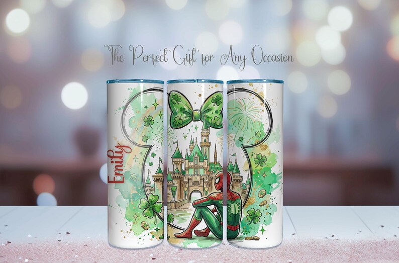 May include: A white tumbler featuring a green bow, a castle, and a seated Spider-Man. The design includes a Mickey Mouse head outline, clovers, and the name "Emily" in red. The text "The Perfect Gift for Any Occasion" is also present.