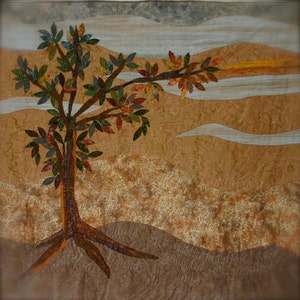 May include: A quilted wall hanging with a brown background and a stylized tree with colorful leaves. The tree is rooted in a field of brown and white leaves. The text "And the mountains founded were, and the hills were established by His word" is written in cursive at the bottom of the image.