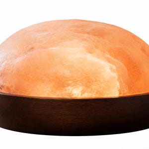 Pode incluir: Uma placa de madeira artesanal com o texto "Welcome" em uma fonte lúdica. A placa apresenta um fundo branco desgastado e uma borda marrom escura, perfeita para uma porta de entrada. Mede aproximadamente 30 cm de largura.