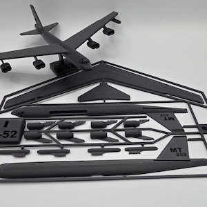 May include: A set of three ceramic mugs with a speckled, matte finish. The mugs are in shades of cream, light gray, and dark gray. Each mug has a simple, minimalist design, perfect for coffee or tea.