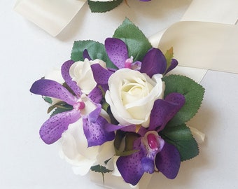 White and purple wrist corsage. White roses, Purple orchids. High school formal, prom. Wedding, mother of the bride, flower wrist corsage.