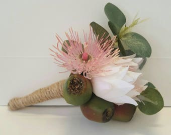 Buttonhole, Boutonniere for groom, groomsmen.  Wedding.   Blushing bride protea flower,  flowering Eucalyptus, gum blossom, gumnut, foliage