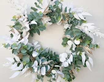 White, green, gold Christmas wreath. Artificial flower christmas decoration. Xmas door, wall hanging. Australian decoration