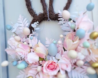 Bunny wreath. Pastel eggs and pink faux flower wreath. Artificial flowers, door decoration. Rabbit ear wreath. Easter gift, Home decoration