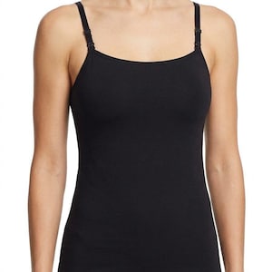 May include: A solid black camisole featuring a scoop neckline and thin, adjustable shoulder straps with small black plastic sliders. The garment has a fitted silhouette and a straight hemline, providing a simple and functional design.
