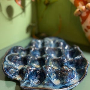 May include: A rustic wooden sign with the text "Welcome to our home" in white lettering. The sign features a distressed finish and a simple, inviting design, perfect for a front porch or entryway.