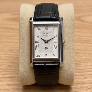 May include: A rustic wooden sign with the text "Welcome to our home" in white lettering. The sign features a distressed finish and a simple, inviting design, perfect for a front porch or entryway.