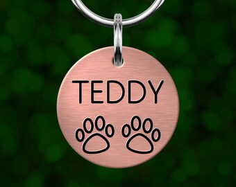 Custom paw prints dog tag. Personalized pet ID with deep engraving. Made in Oregon.