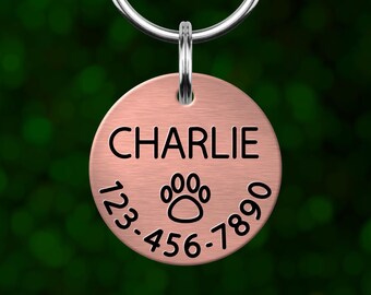 Custom paw print dog tag. Personalized pet ID with deep engraving. Made in Oregon.