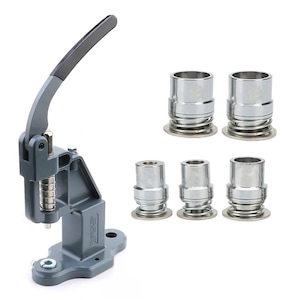 May include: A gray metal hand press with a black handle and a set of silver metal dies. The press has a spring mechanism and a base with a mounting hole. The dies are cylindrical with a flared base.