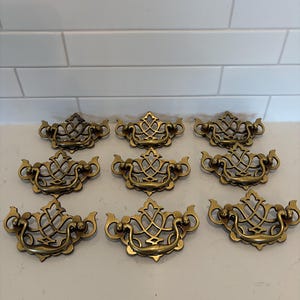 May include: A set of three ceramic mugs with a speckled, matte finish. The mugs are in shades of cream, light gray, and dark gray. Each mug has a simple, minimalist design, perfect for coffee or tea.