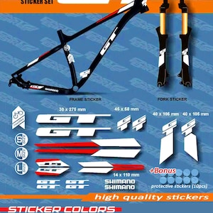 May include: A sticker set for a bicycle frame and fork, featuring the "GT" logo and Shimano branding. The set includes various stickers in white, black, and red, with dimensions provided in inches and millimeters. The set also includes protective stickers.