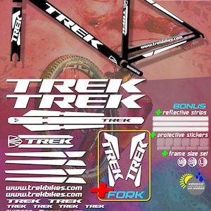 May include: A set of black and white Trek frame stickers. The image includes the Trek logo, Shimano, and website address. The stickers are waterproof, sun-resistant, and easy to apply. Bonus reflective strips and protective stickers are included.